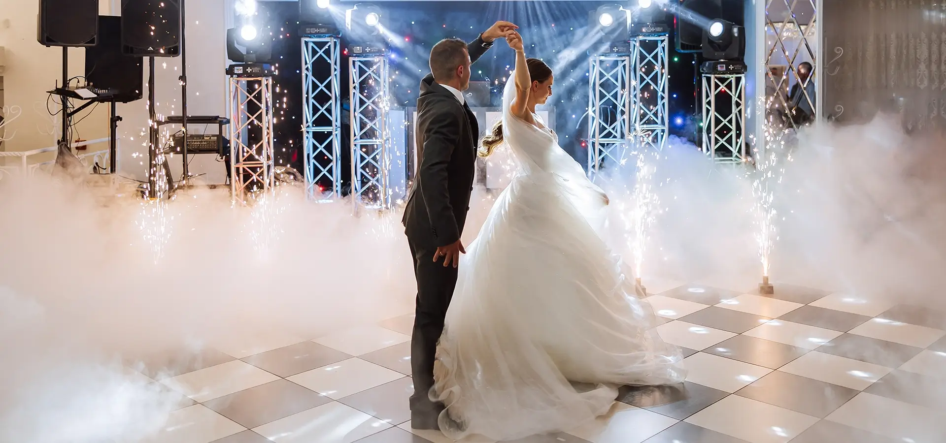 Bride and groom first dance with guests around them